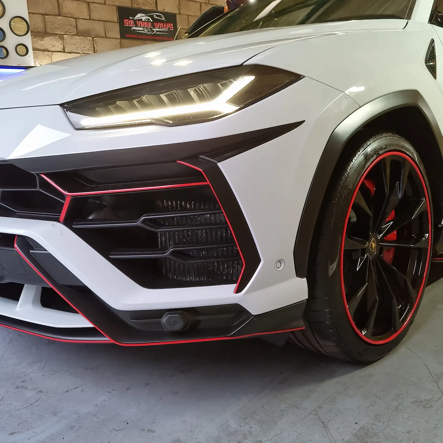 White Lamborghini Urus with red accent detailing at SDL Vinyl Wraps & Customs, Chatsworth